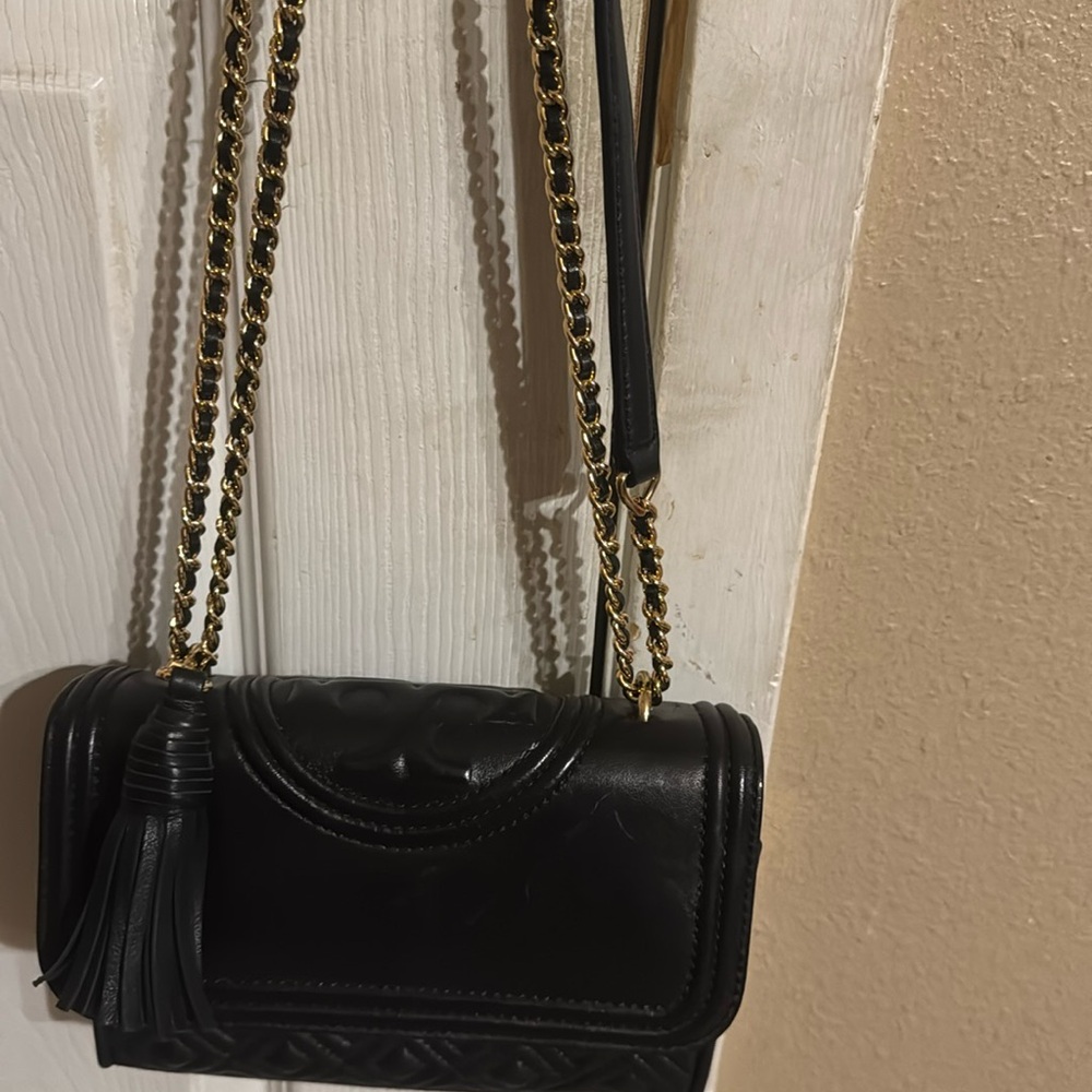 Black Tory Burch crossbody with chain straps.